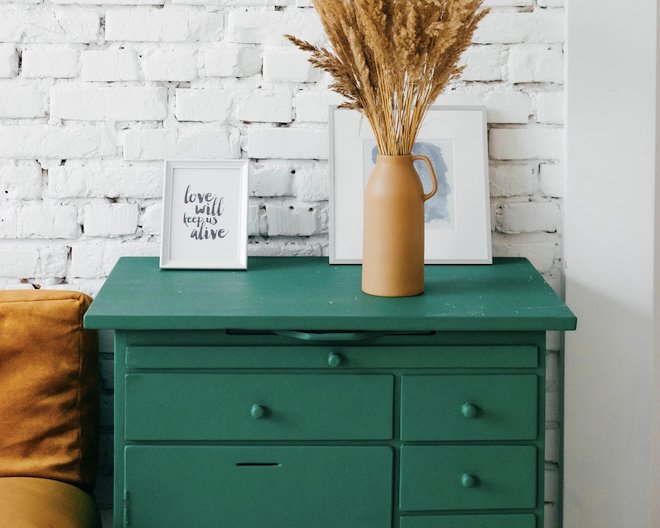 A green cabinet in a stylish modern room